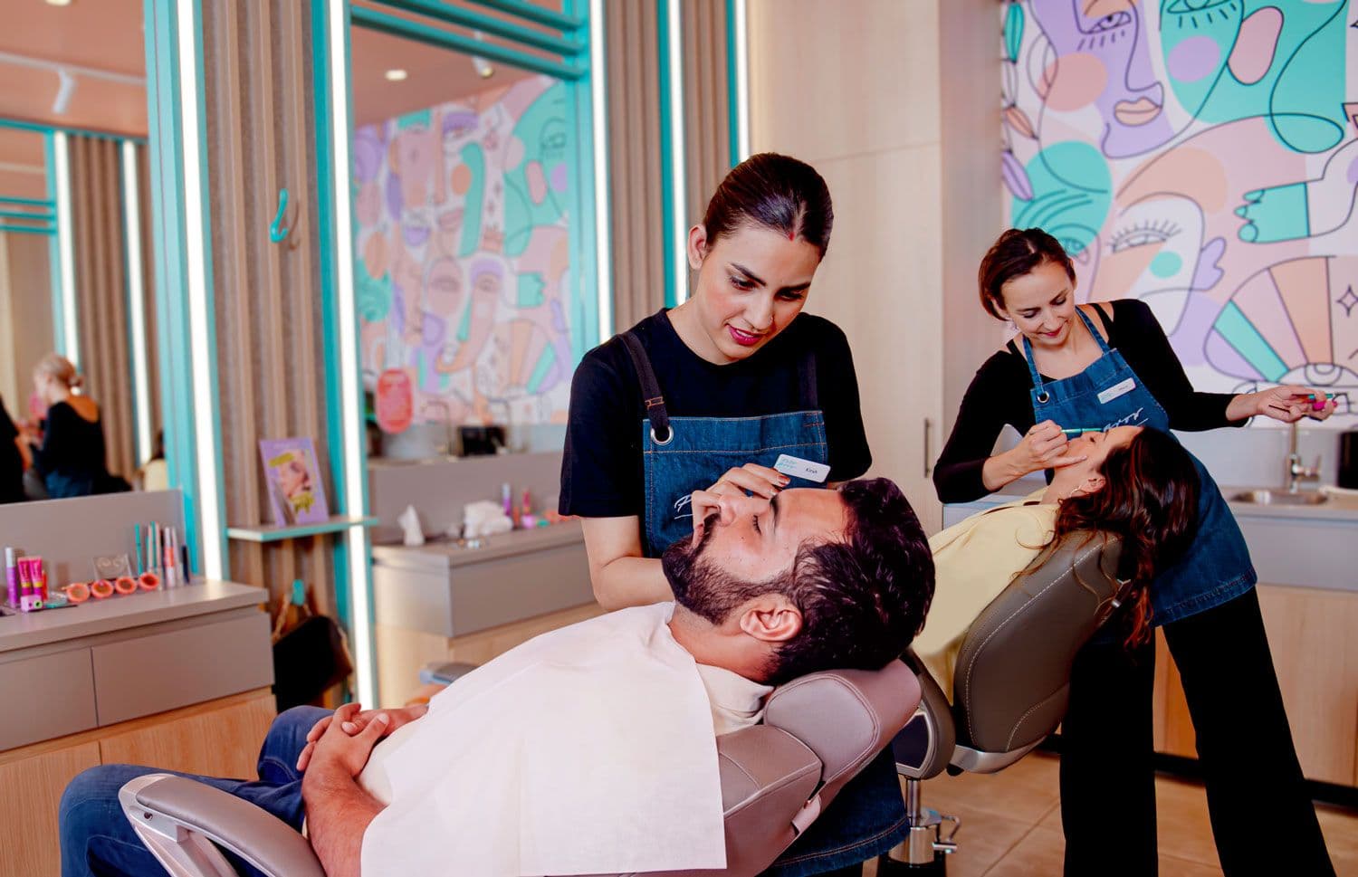 Full Brow Bar stylist threading a male customer's brows